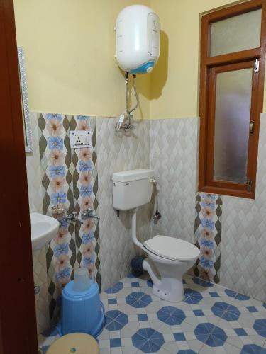 a bathroom with a toilet and a sink at Sejal Homestay in Shimla
