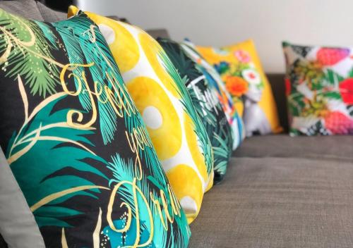 a row of colorful pillows on a couch at The Bay Condominium, 1-bed apartment with stunning sea views in Koh Samui