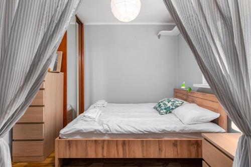 a small bedroom with a bed and a window at Wałowa 4 by Homeprime in Warsaw