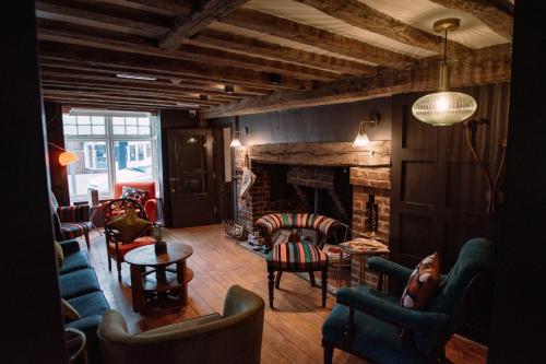 a living room with couches chairs and a fireplace at The Print House Inn in Kent