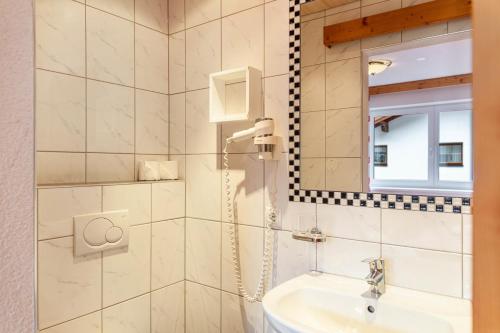 a bathroom with a sink and a mirror at Alpenflora 1 in Ischgl
