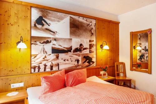 a bedroom with a bed and a large picture on the wall at Alpenflora 1 in Ischgl