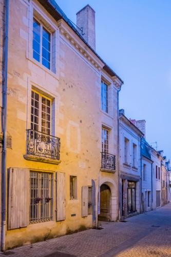 an old building on the side of a street at Logis Cointereau in Baugé-en-Anjou