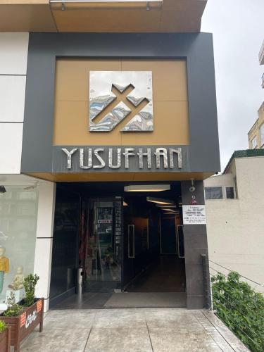 a building with a sign on the front of it at Yusufhan Suites in Trabzon