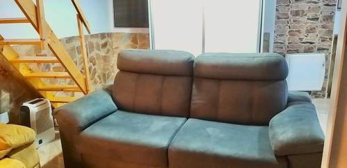 a brown leather couch sitting in a living room at Loft-Duplex Centro City in Montilla