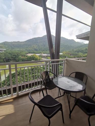 a table and chairs on a balcony with a view at Pico De Loro Room Rate in Nasugbu
