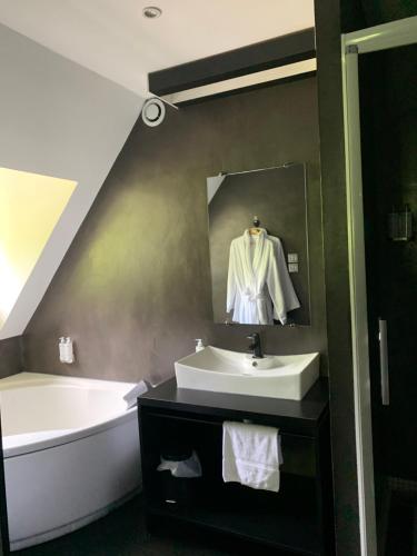 een badkamer met een wastafel en een bad bij Moulin de Cambelong- Emilie & Thomas in Conques-en-Rouergue