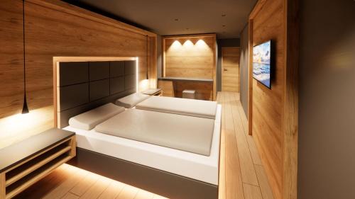 a large white tub in a room with wooden walls at Alpen-Herz Romantik & Spa - Adults Only in Ladis