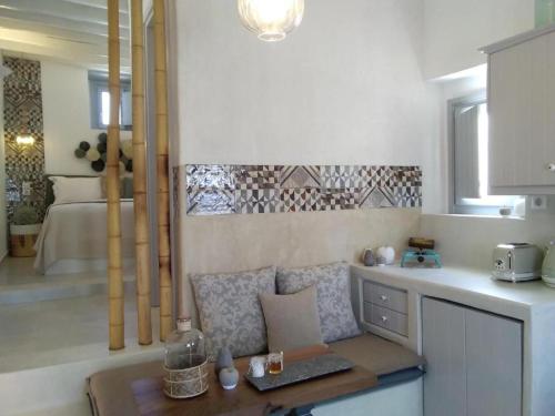 a kitchen with a couch and a bed in the background at Esperia Luxury Suites in Astypalaia Town