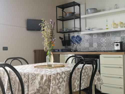 a kitchen with a table with a vase of flowers on it at Villa Calcerame in Montelepre