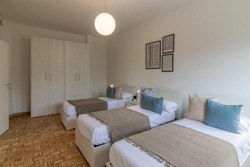 a hotel room with two beds and a couch at Fiera di Ferrara Huge Apartment x7! in Ferrara