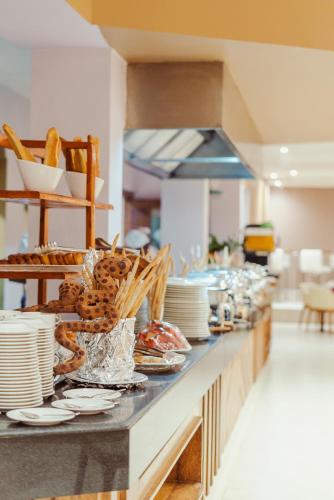 a buffet line with plates and dishes on it at Tanga Beach Resort & Spa in Tanga