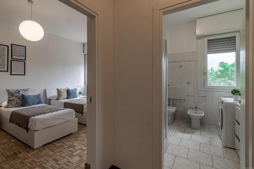a bedroom with a bed and a bathroom at Fiera di Ferrara Huge Apartment x7! in Ferrara