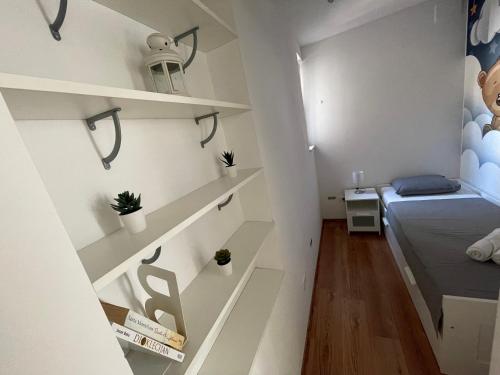 a small room with white shelves and a bed at Apartment “Jelin dvor” 3+2, Bacvice, Split in Split