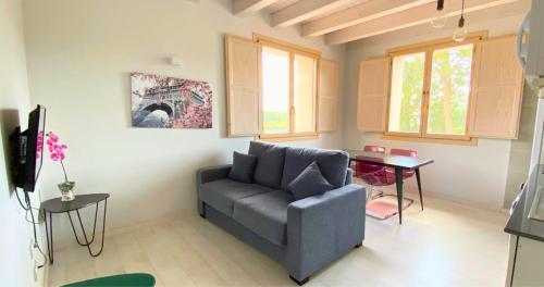 a living room with a couch and a table at Apartamentos La Harinera in Torres de Albarracín