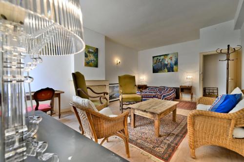 a living room with chairs and a table at Logis Cointereau in Baugé-en-Anjou