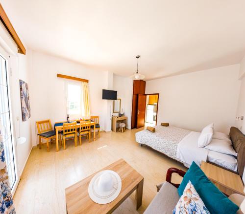 a bedroom with a bed and a living room at Anna Ageliki in Damnoni