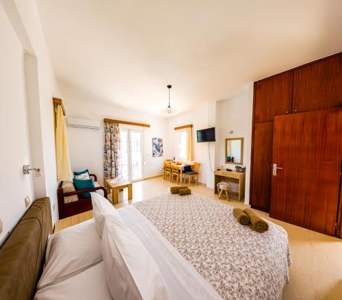 a bedroom with a large bed and a living room at Anna Ageliki in Damnoni