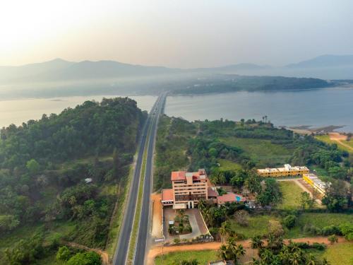 an aerial view of a road next to a body of water at Sterling Karwar in Kārwār