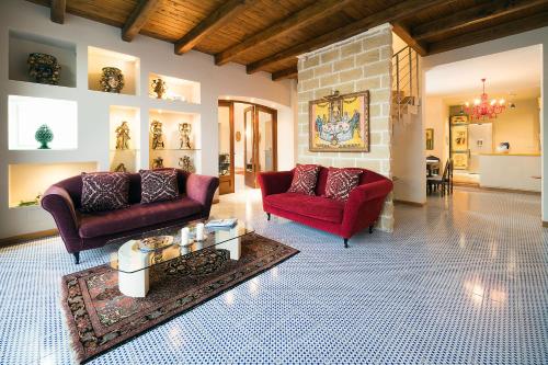 a living room with two couches and a brick wall at La Boheme in Taormina