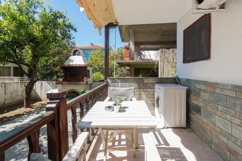 a white table and chairs on a balcony at Stefanias apartment in Neos Marmaras