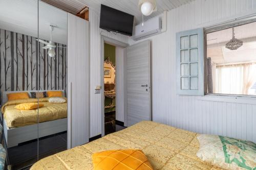 a bedroom with two beds and a mirror at Chalet Melody in Santa Croce Camerina