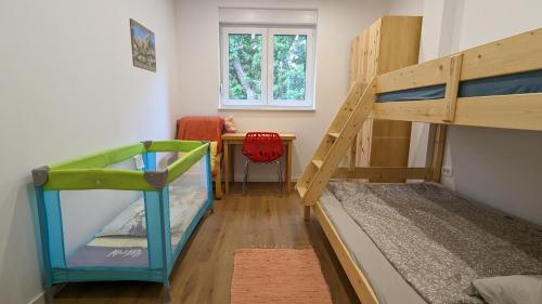 a room with two bunk beds and a desk at Apartment in an urban villa Kraljevica in Kraljevica