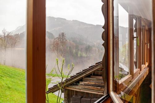 a window of a train looking out at the mountains at Ferienhaus Dünser in Bizau