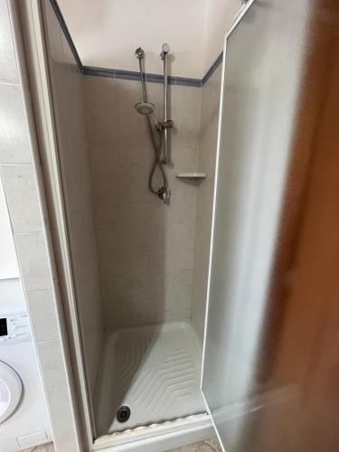 a shower with a glass door in a bathroom at Casa Costera in Orosei