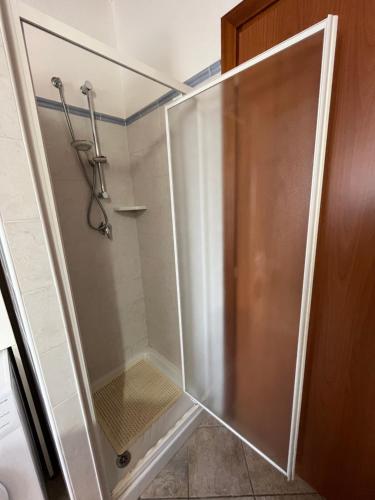 a shower with a glass door in a bathroom at Casa Costera in Orosei