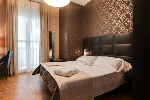 a bedroom with a large bed with a black headboard at Atmosfere Milano Marittima in Milano Marittima