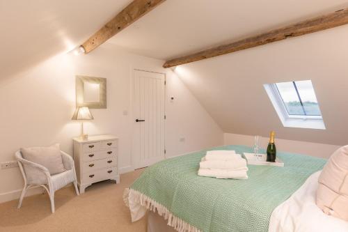 a bedroom with a bed and a chair and a window at Angram Cottage in Thirsk