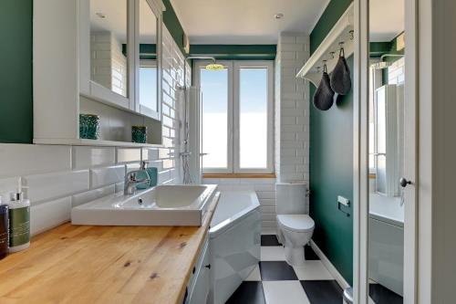 a bathroom with a sink and a toilet at Downtown Apartments Angielska Grobla Street in Gdańsk