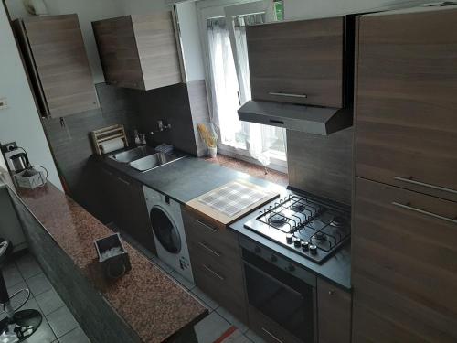 a kitchen with a stove and a washing machine at Case Gemelle - CIR 0271 in Aosta