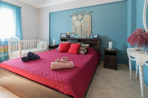 a bedroom with a bed with two pairs of slippers on it at Aurelia Apartment in Lixouri