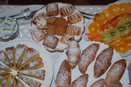 a table with a tray of different types of food at Il Rondò Boutique Hotel in Montepulciano