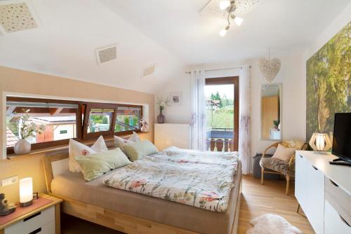 a bedroom with a bed and a desk and a television at Mutschler in Freudenstadt