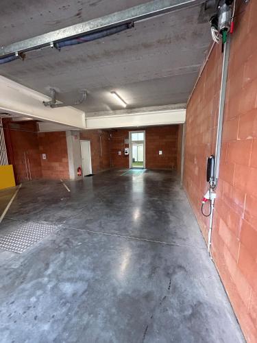 an empty room with a brick wall at Cadix 35 in Antwerp