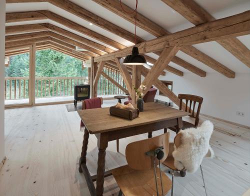 a dining room with a wooden table and chairs at Alpeltalhütte in Schönau am Königssee