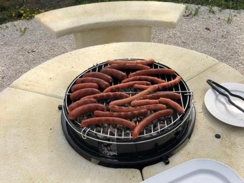 a bunch of hot dogs cooking on a grill at Napvirág-Ház in Zsira