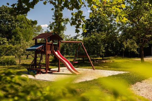 a playground with a slide in a park at Napvirág-Ház in Zsira