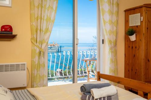 a bedroom with a bed and a view of the ocean at Mer Vue - 3 floor Private House by the Sea in Split