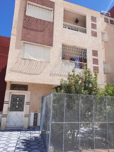 a building with a fence in front of it at DARY in Fès