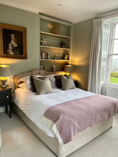 a bedroom with a large bed and a window at Burleigh Court Hotel in Stroud