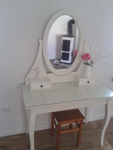 a white dressing table with a mirror on it at Penzion a hospoda Na statku in Hluboká nad Vltavou