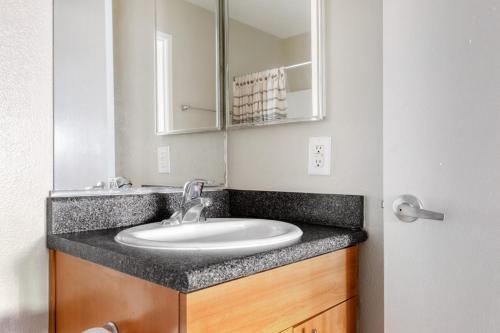 a bathroom with a sink and a mirror at Woodland Hills 1BR w Gym WD Pool nr 101 LAX-683 in Los Angeles