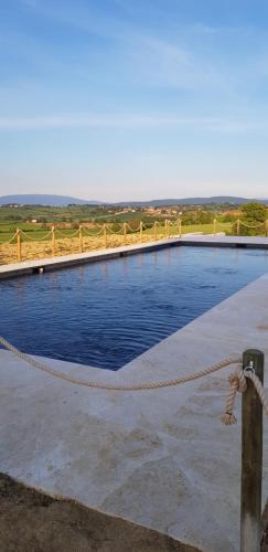 a swimming pool with a rope around it at Al Dolce Far Niente Dimora con piscina di Design in San Biagio della Valle