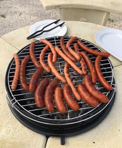 a bunch of hot dogs cooking on a grill at Napvirág-Ház in Zsira
