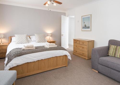 a bedroom with a large bed and a couch at Greenleaf in Bamburgh