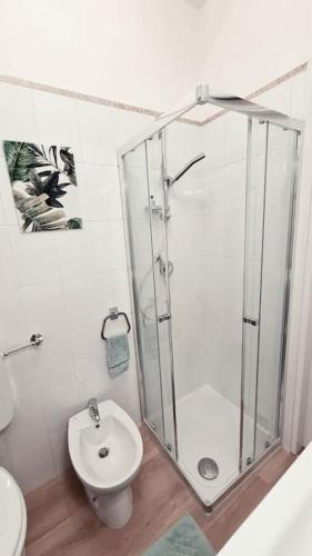 a bathroom with a shower and a toilet and a sink at Casa degli Ulivi 19 in Faedis